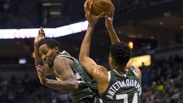 Milwaukee Bucks forward Giannis Antetokounmpo (34) grabs a rebound above guard Brandon Jennings (11) 